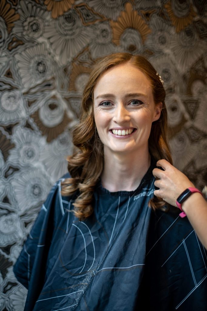 a redhead bride has her hair done before her hertfordshire wedding