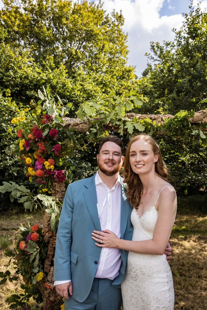 a bride and groom kiss under the alter at Hertfordshire summer wedding