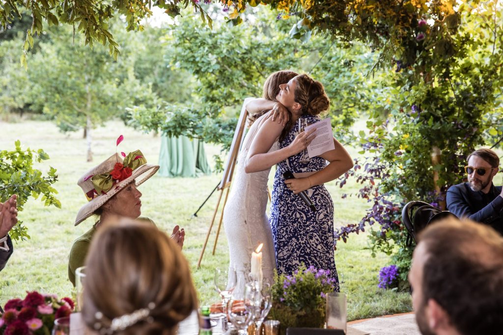 the bride hugs sister in law at hertfordshire wedding