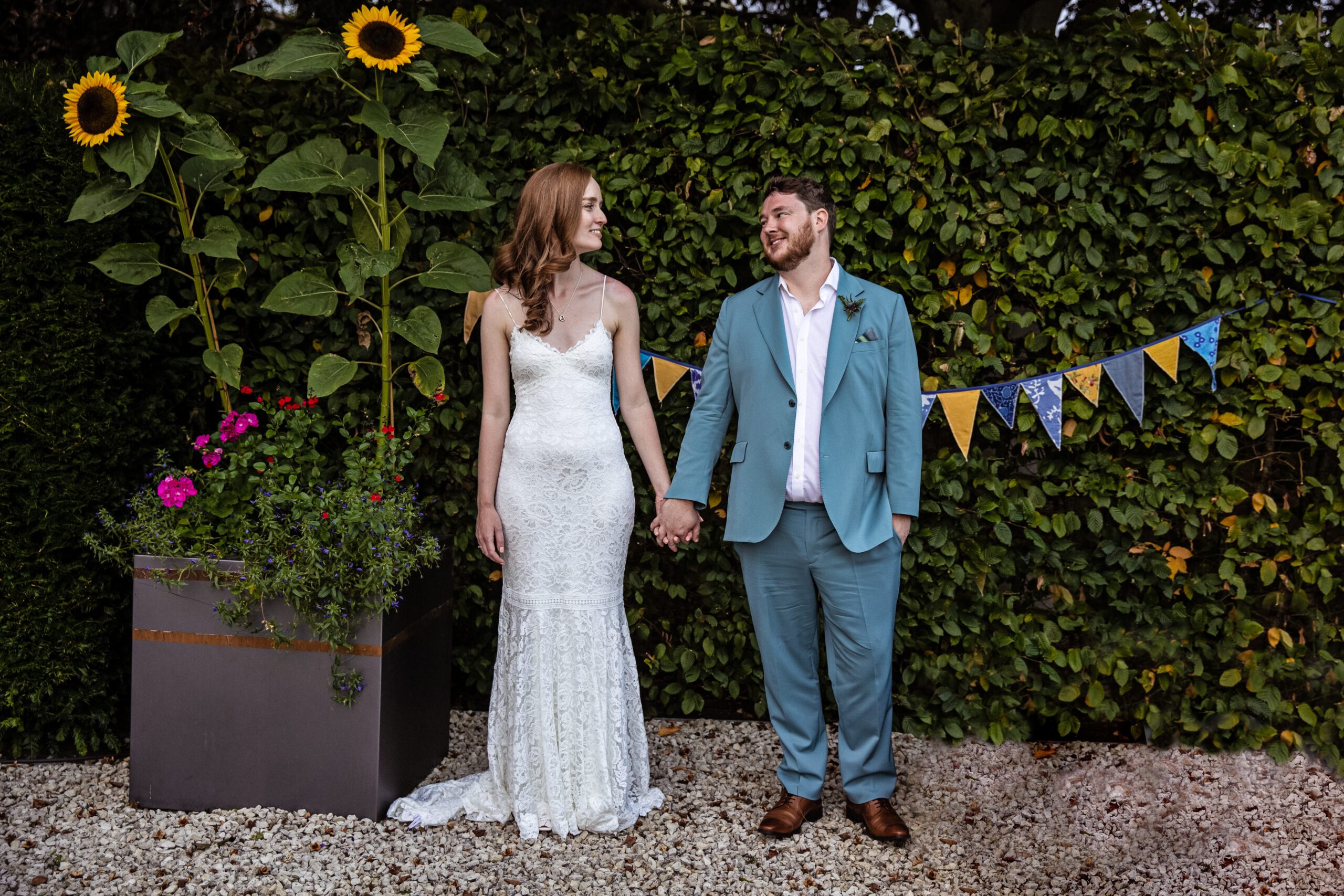 Hertfordshire wedding photography, Bride and groom pose in an embrace in a floral garden
