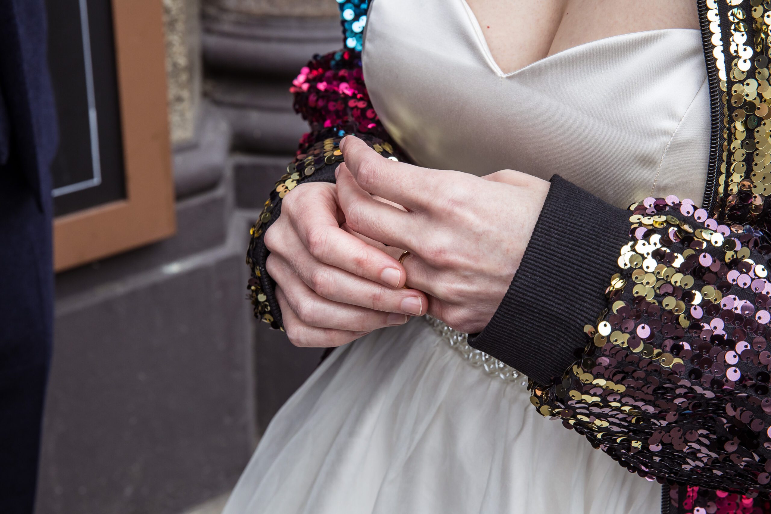 A bride plays with her ring on her wedding day outside Balfour St Barts pub in London