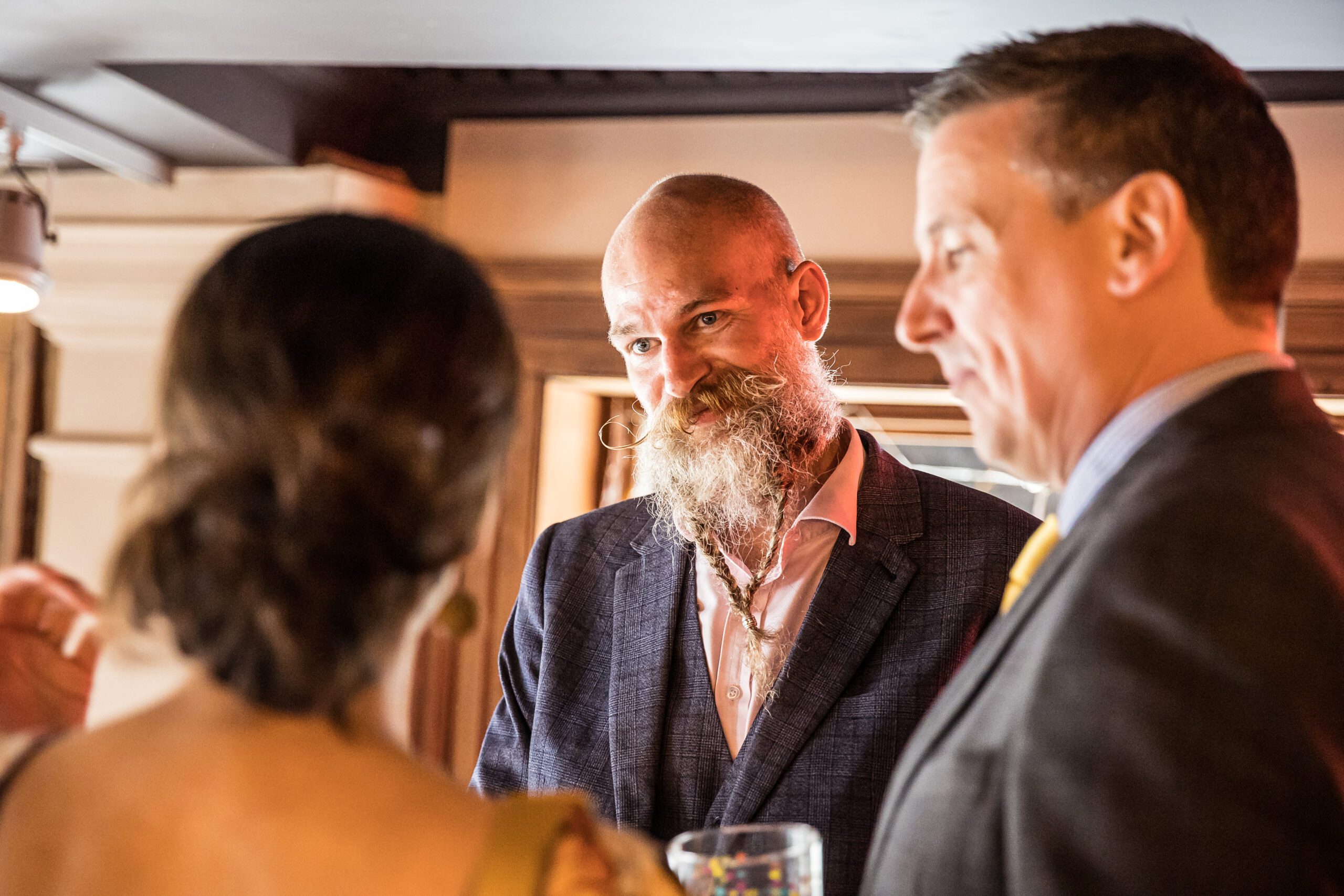A guest smiles as he chats to family at a wedding at Balfour St Barts in London
