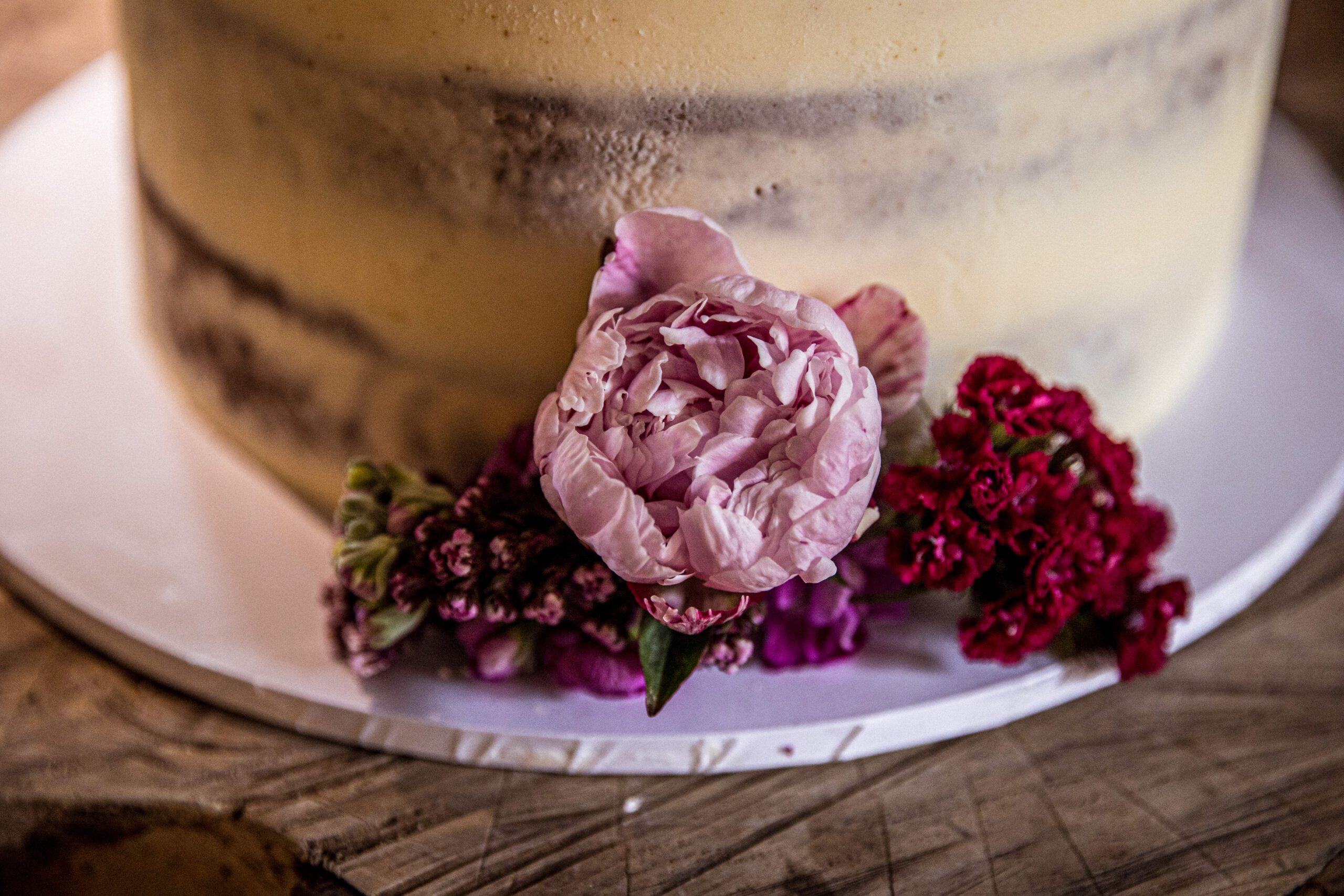 A close up shot of roses on a wedding cake at Balfour st barts