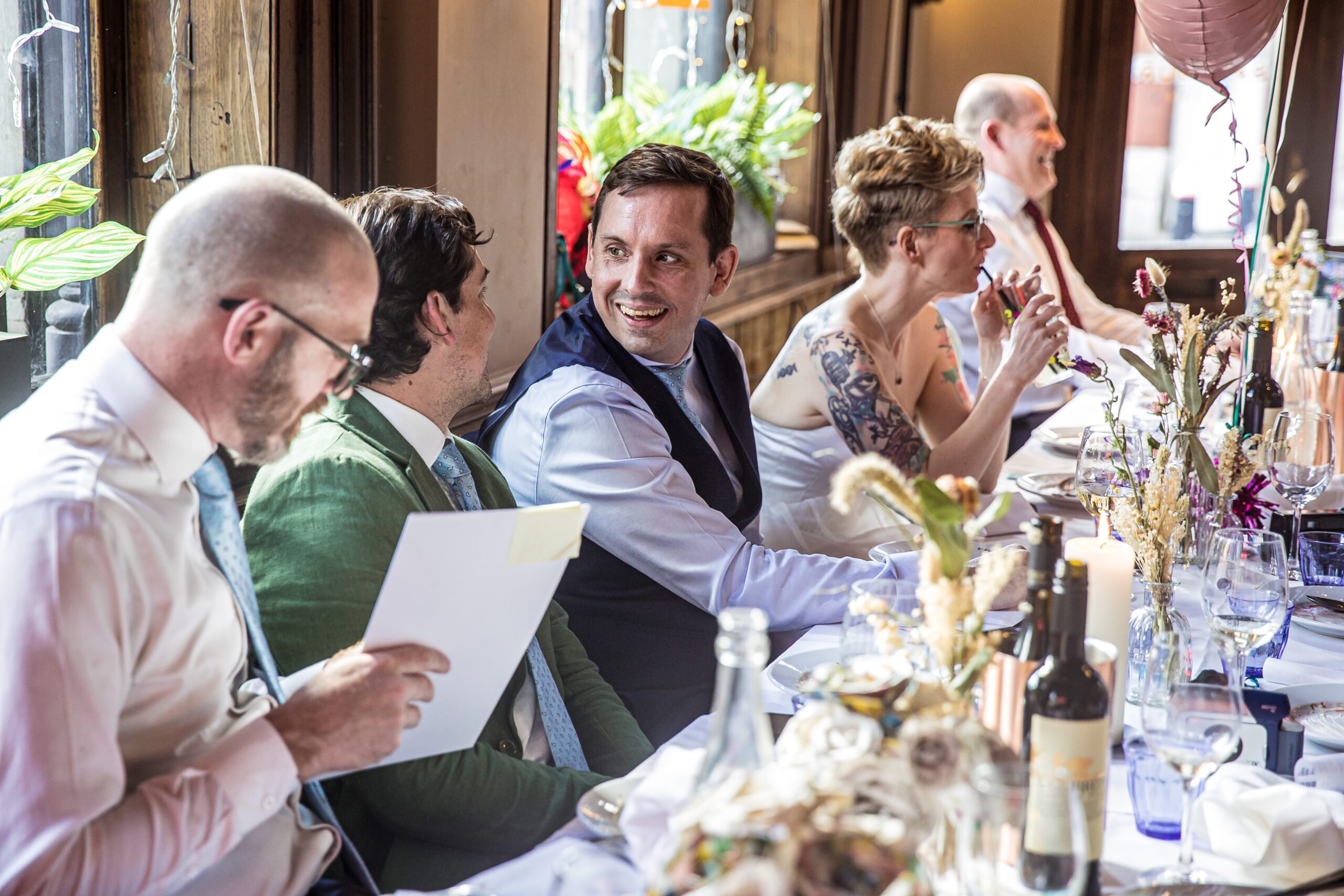 The groom smiles at his best men at his wedding breakfast at Balfour st Barts wedding