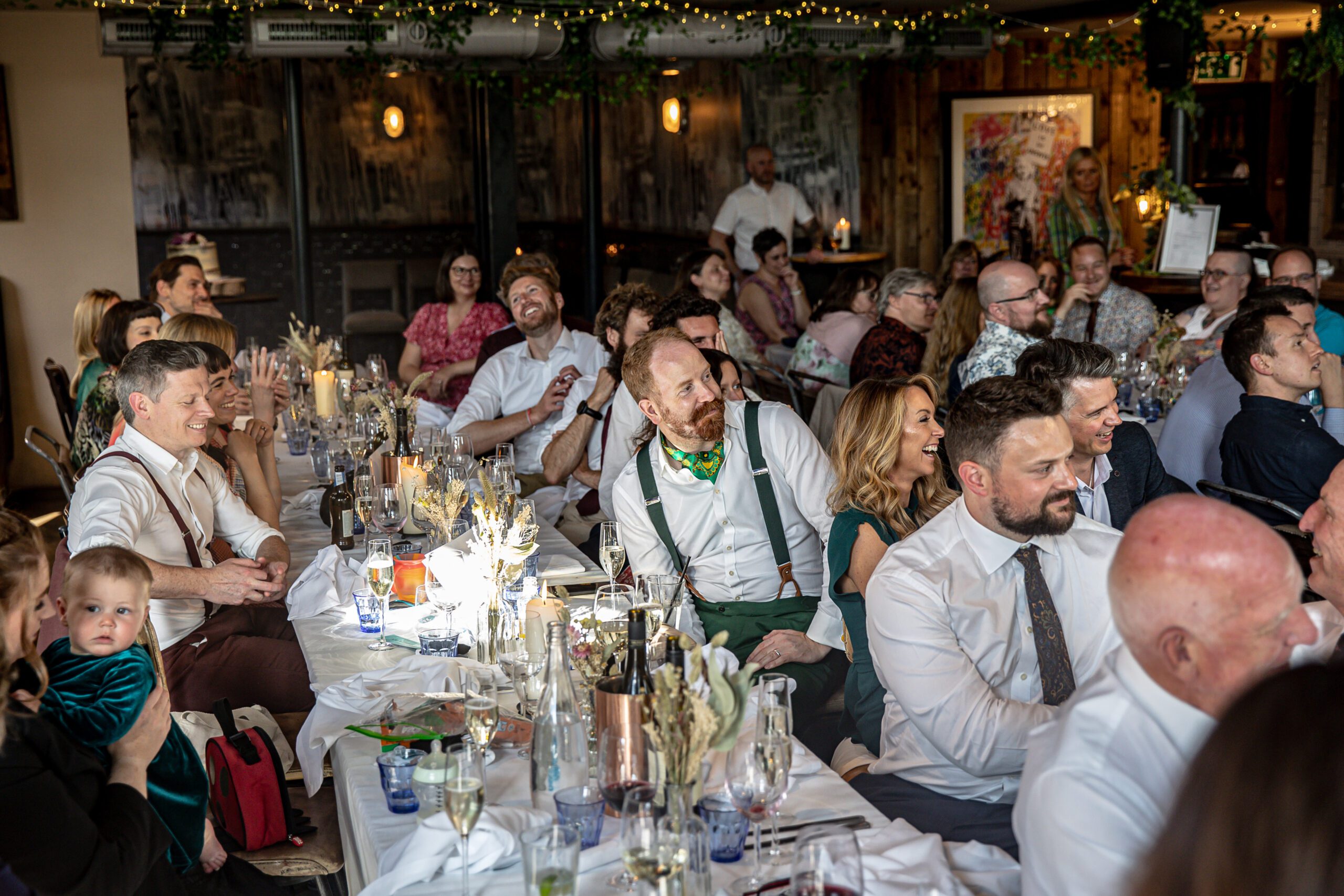 The guests laugh during speeches at a wedding at Balfour St Barts.