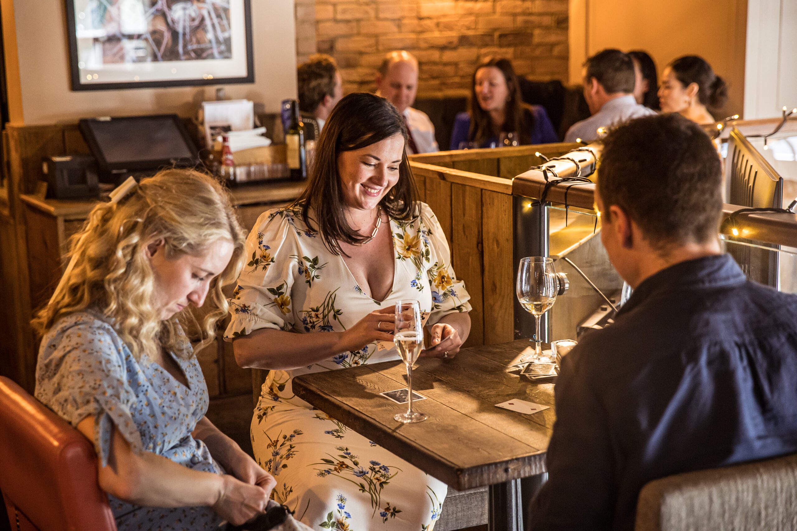 Wedding guests play card games at a London pub wedding at Balfour St Barts