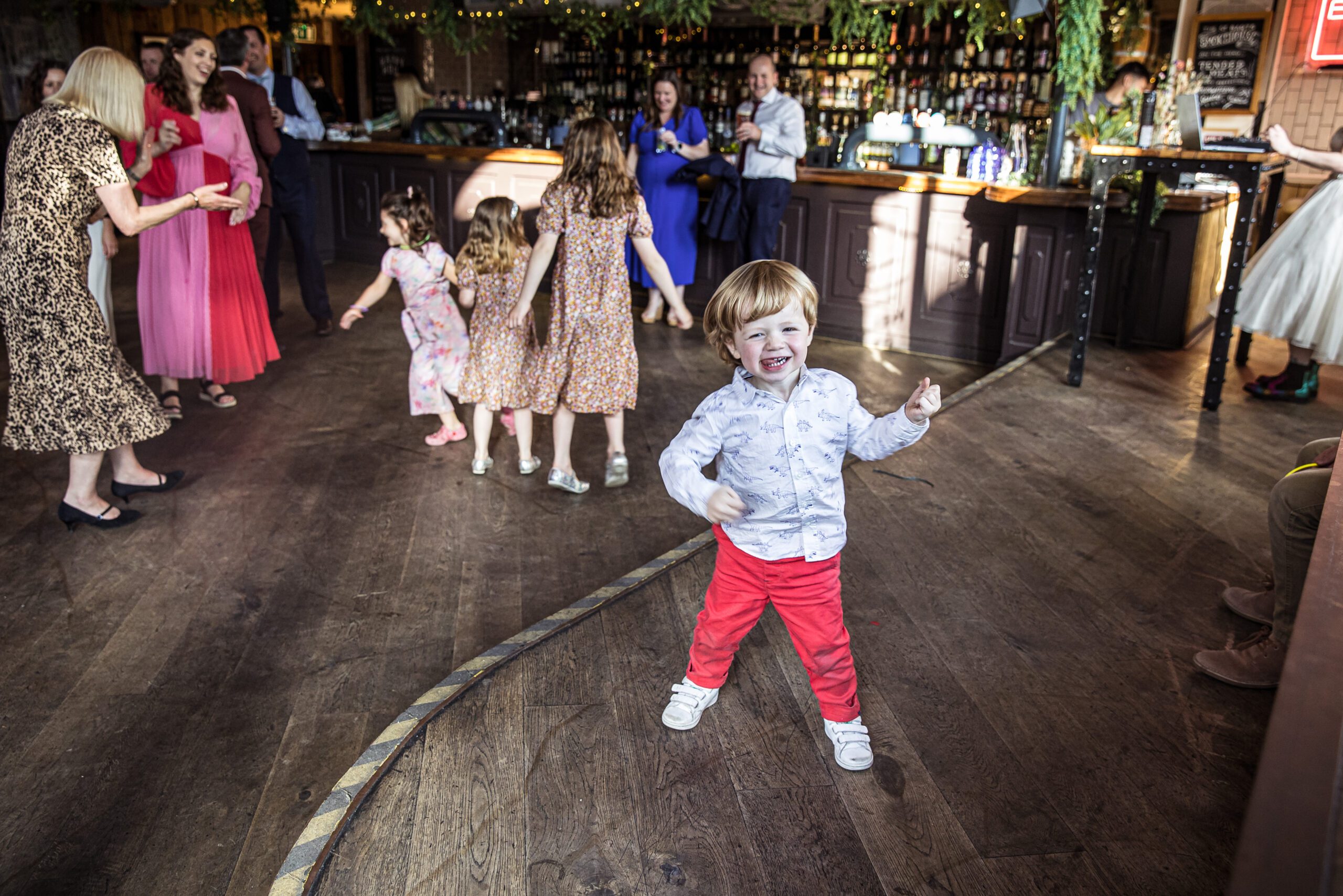 A little boy dances on stage at a london pub wedding at Balfour st barts