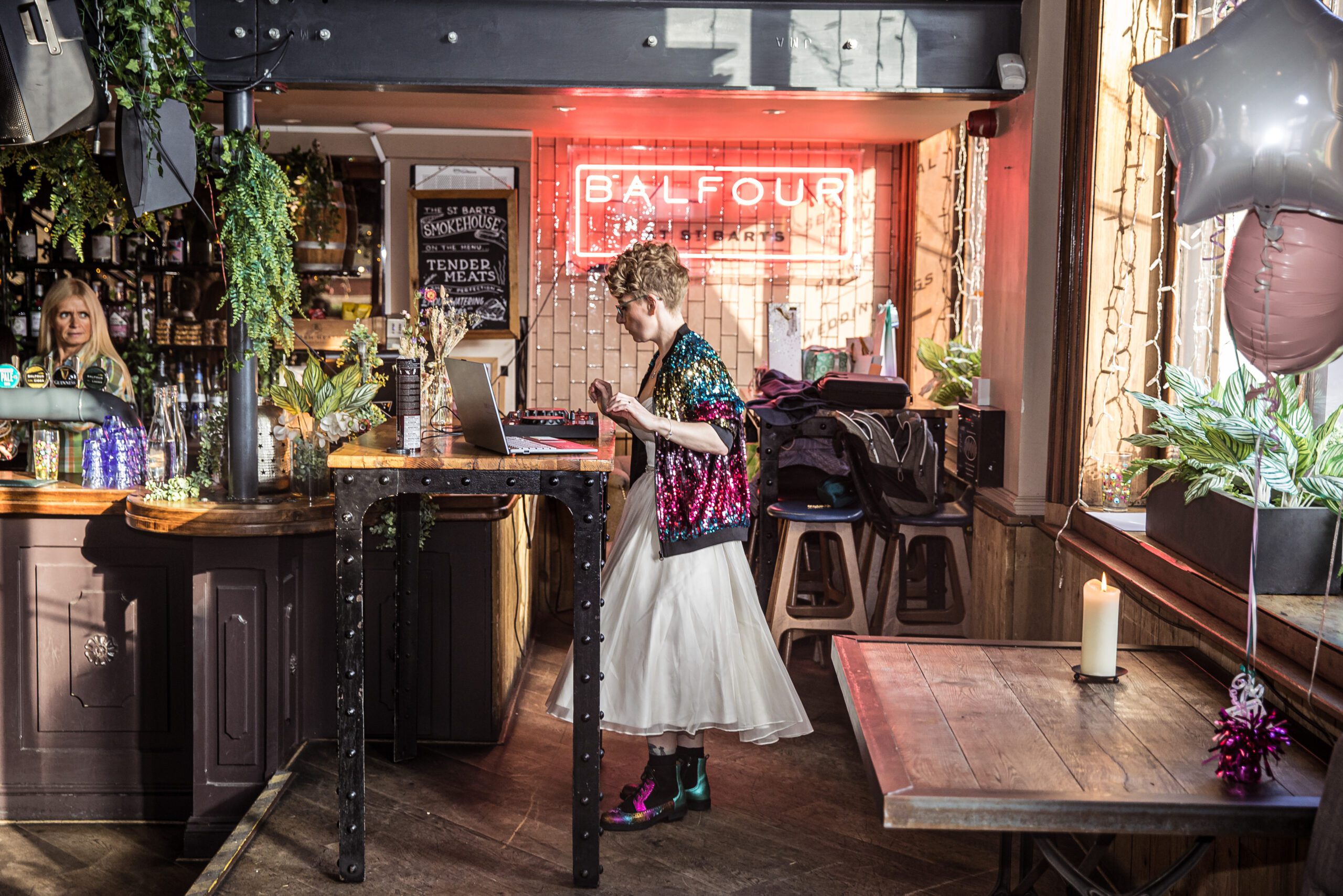 The bride mixes songs on a deck at her london wedding at Balfour st barts
