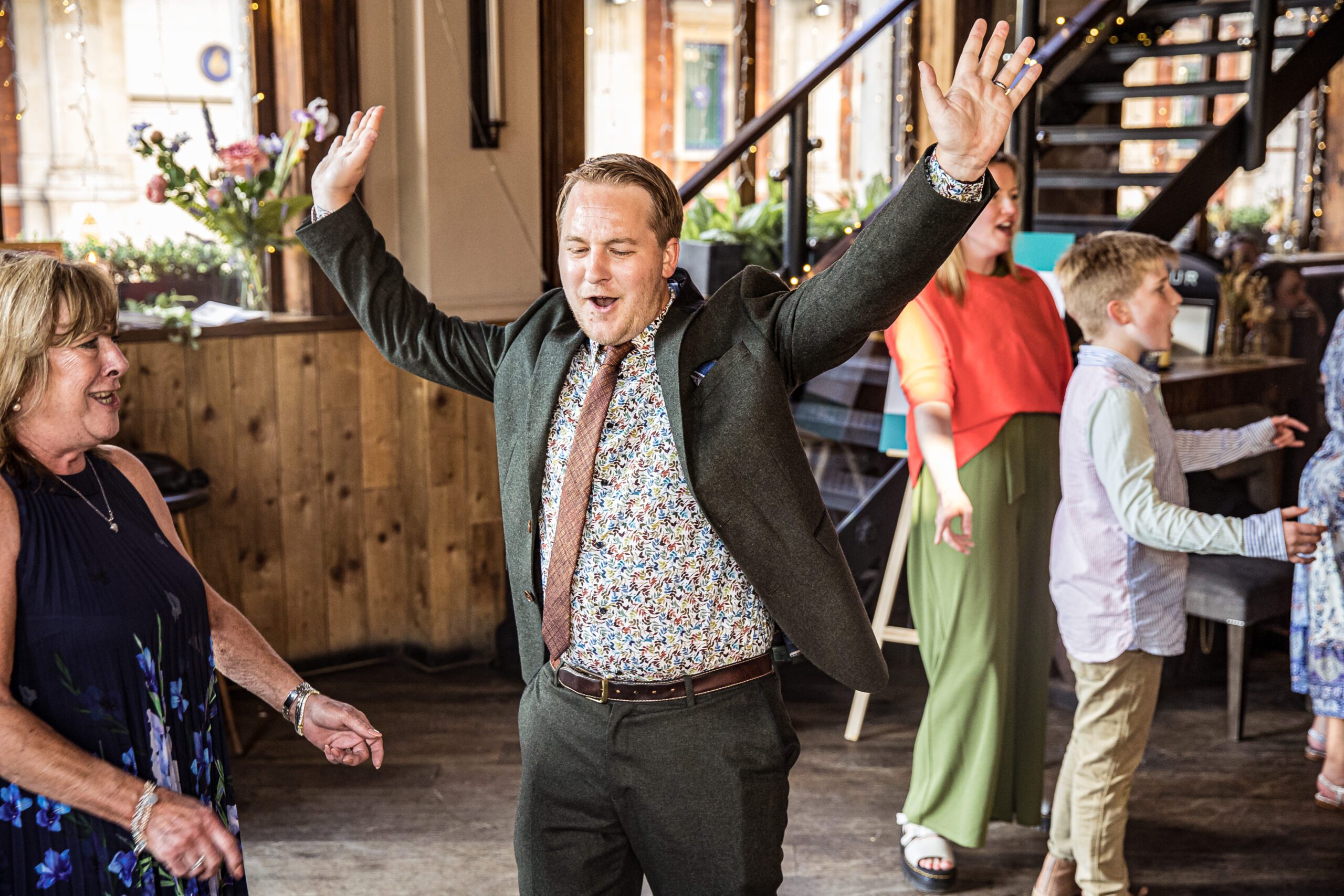 a wedding guest dances with his hands in air at Balfour st Barts wedding in London