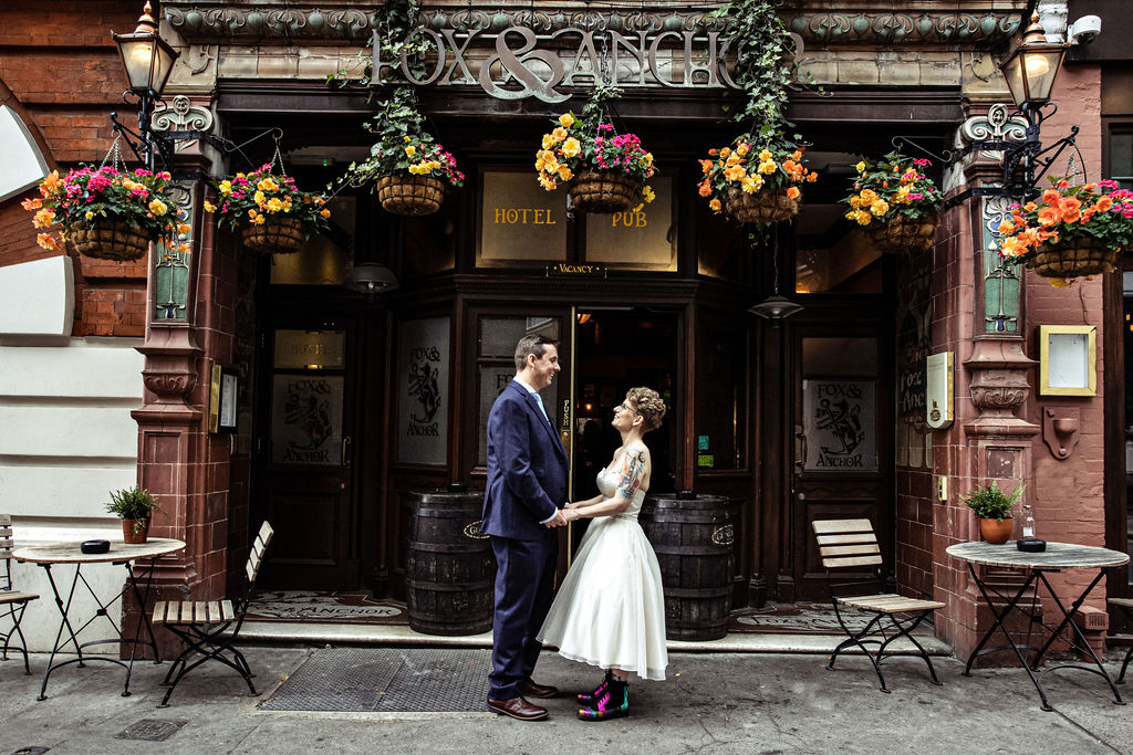 The bride and groom are seated as their ceremony begins at Balfour St Barts in London